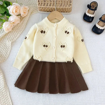 Rosafarbenes Set aus Strickjacke und Rock mit Blumenmuster für Mädchen