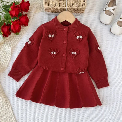 Rosafarbenes Set aus Strickjacke und Rock mit Blumenmuster für Mädchen
